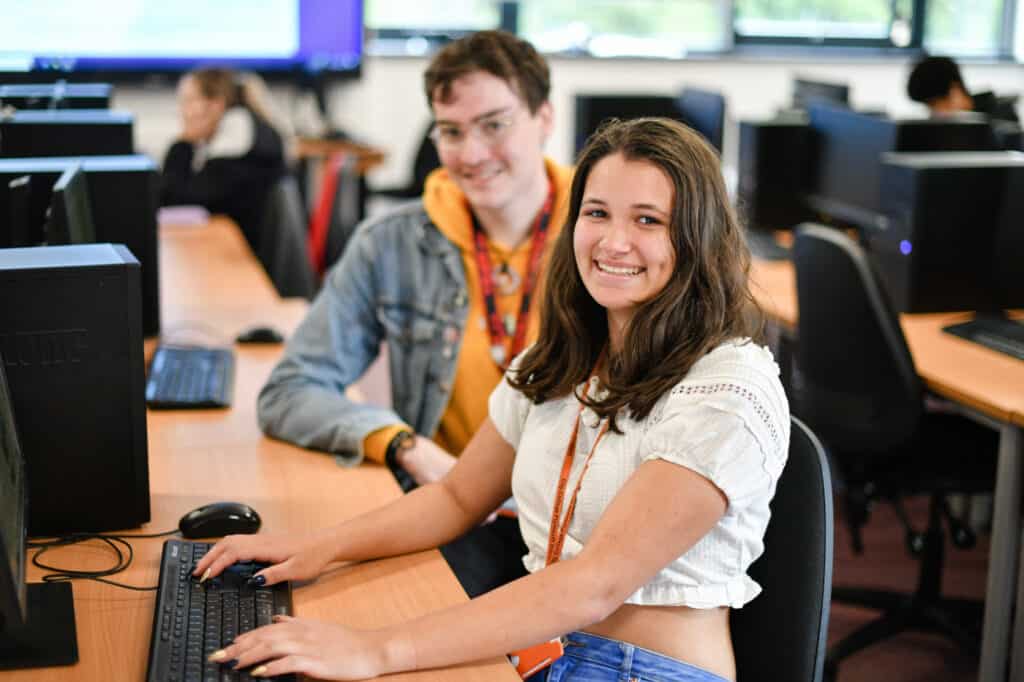 Happy students on a computer