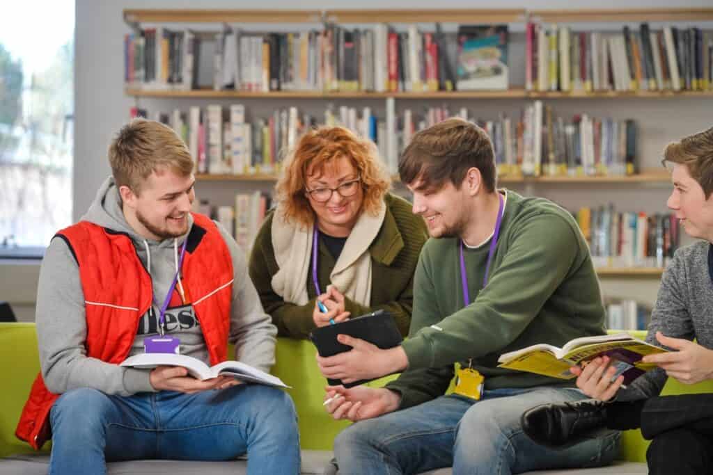 Group of adult students talking in the library