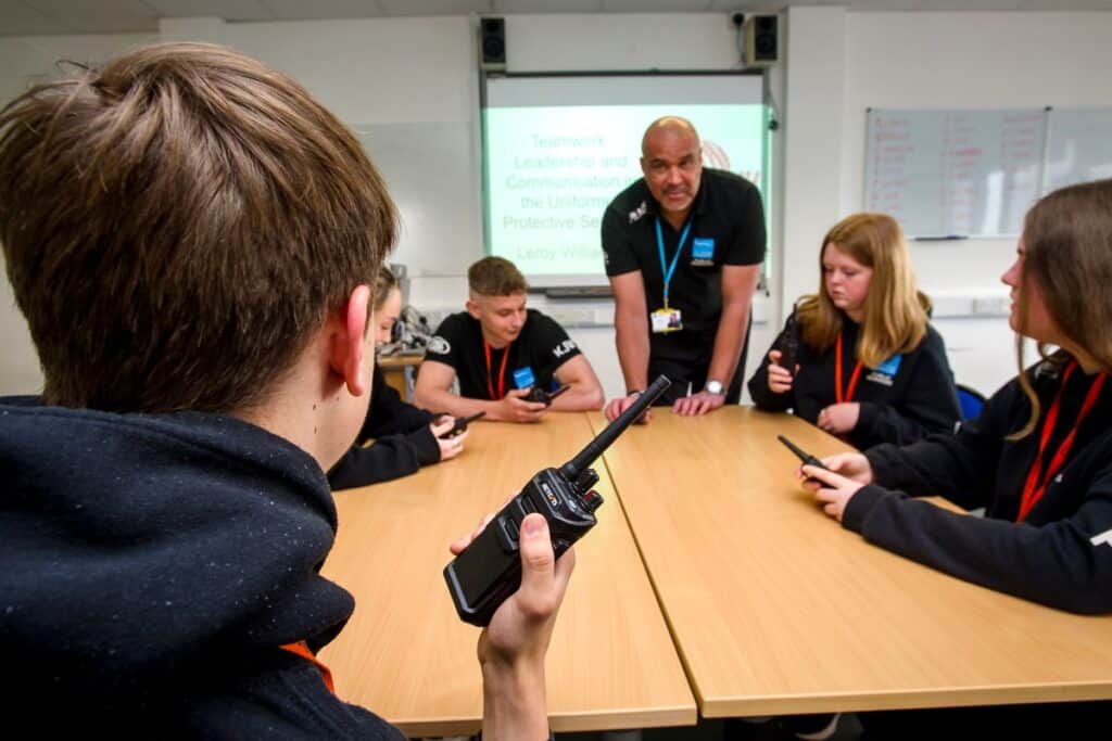 Group of students learning about communications equipment