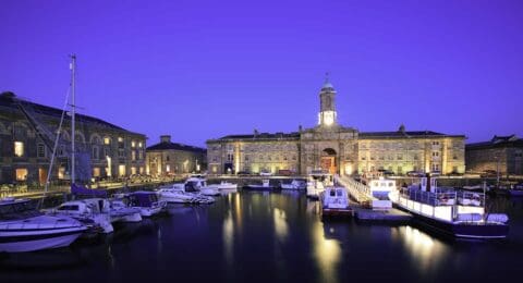 A low light night scene of the Royal William yard harbour. This is a nearly developed part of Plymouth which host a number of restraints and a leisure harbour. A popular place for visitors to the city.The picture was captured at night which a long exposure creating some movement in the water and boats.