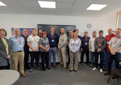 Princess Yachts graduates pose in a classroom with CEO Will Green at City College Plymouth