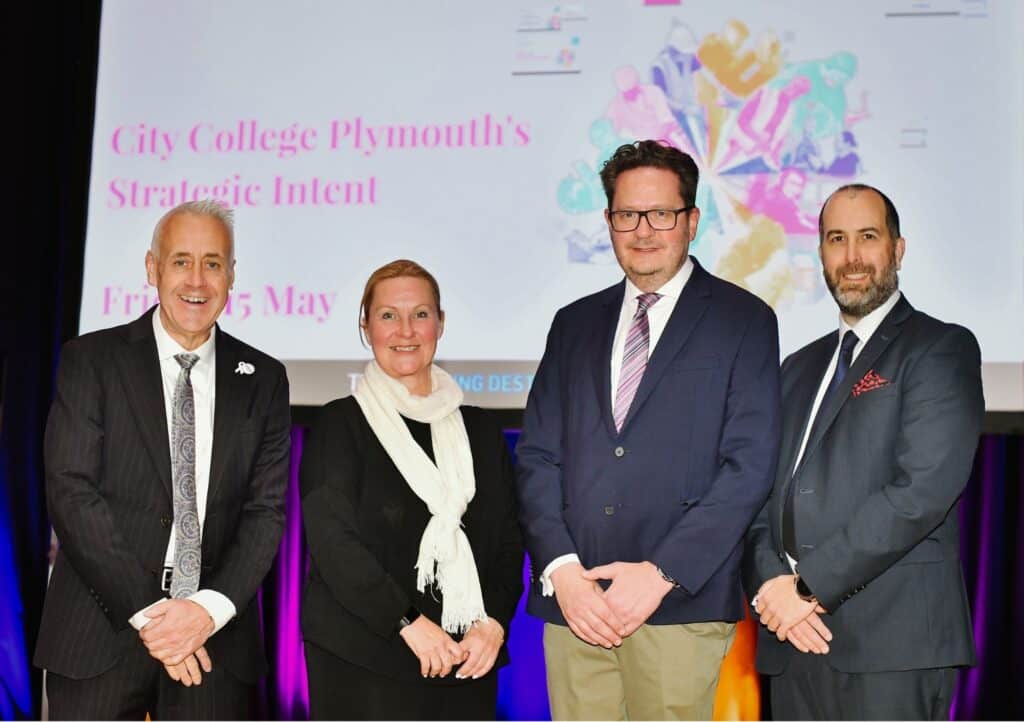 City College CEO Jackie Grubb with 3 male guest speakers at the Strategic Intent event