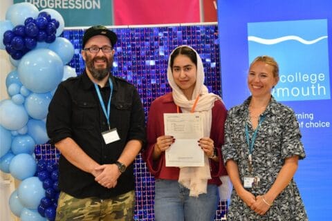 Girl with GCSE result and staff members